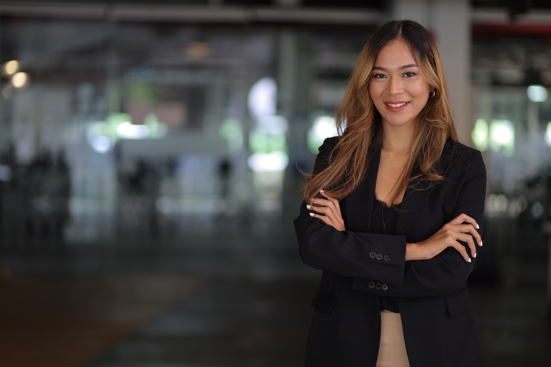 Portrait of a happy charming business woman looking at the camera in the office.